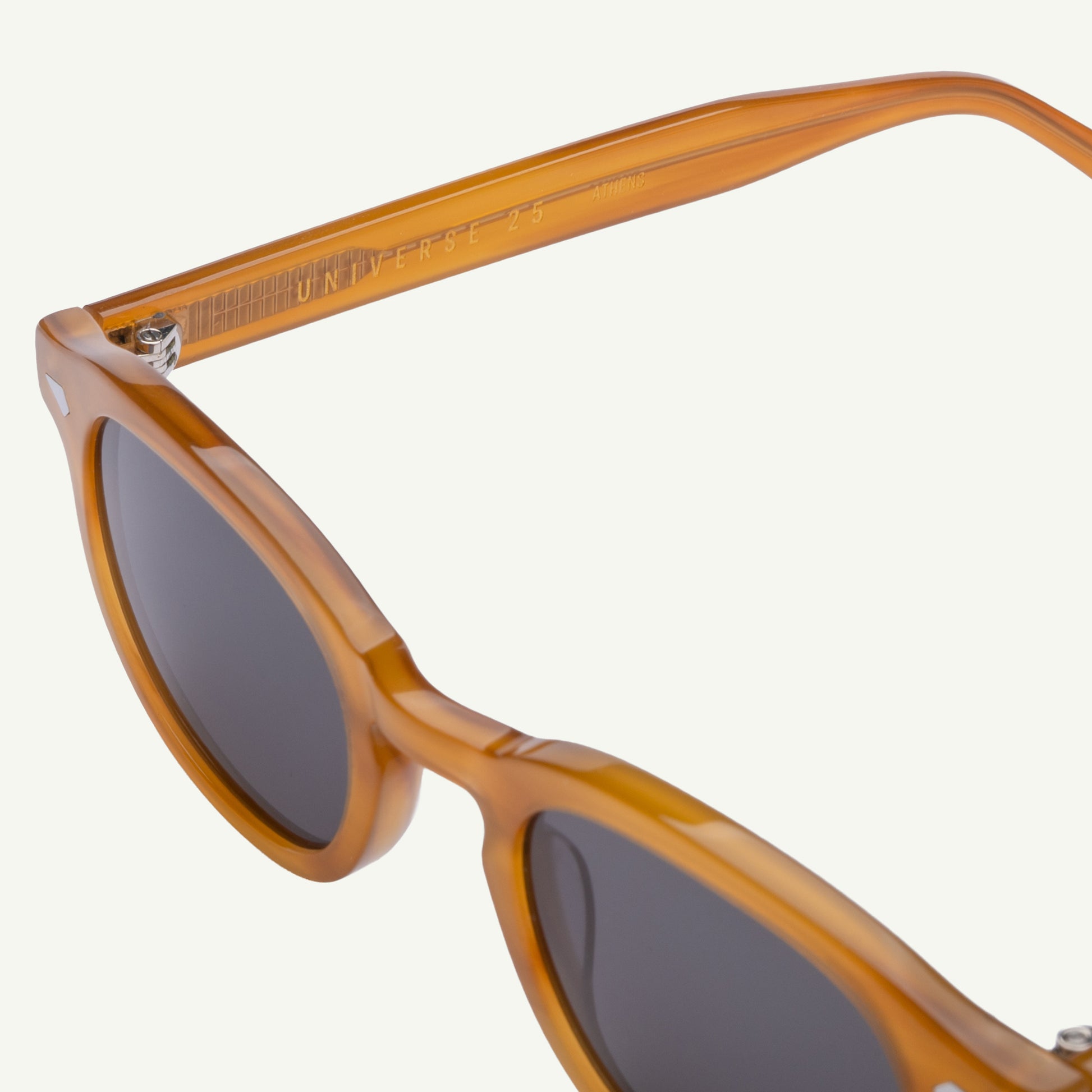 Brown sunglasses with dark lenses on a white background