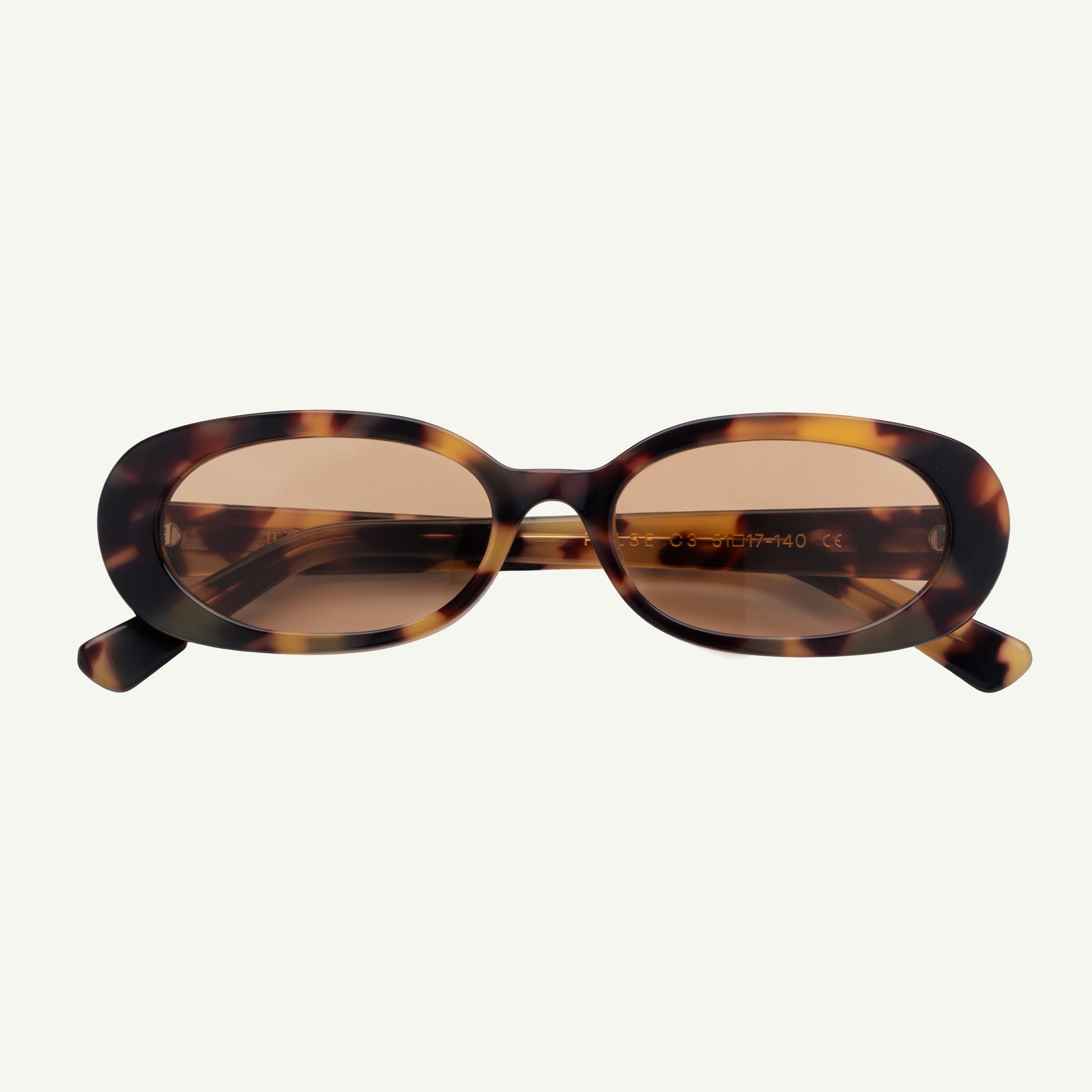 Sunglasses with tortoiseshell frame and brown lenses on a white background