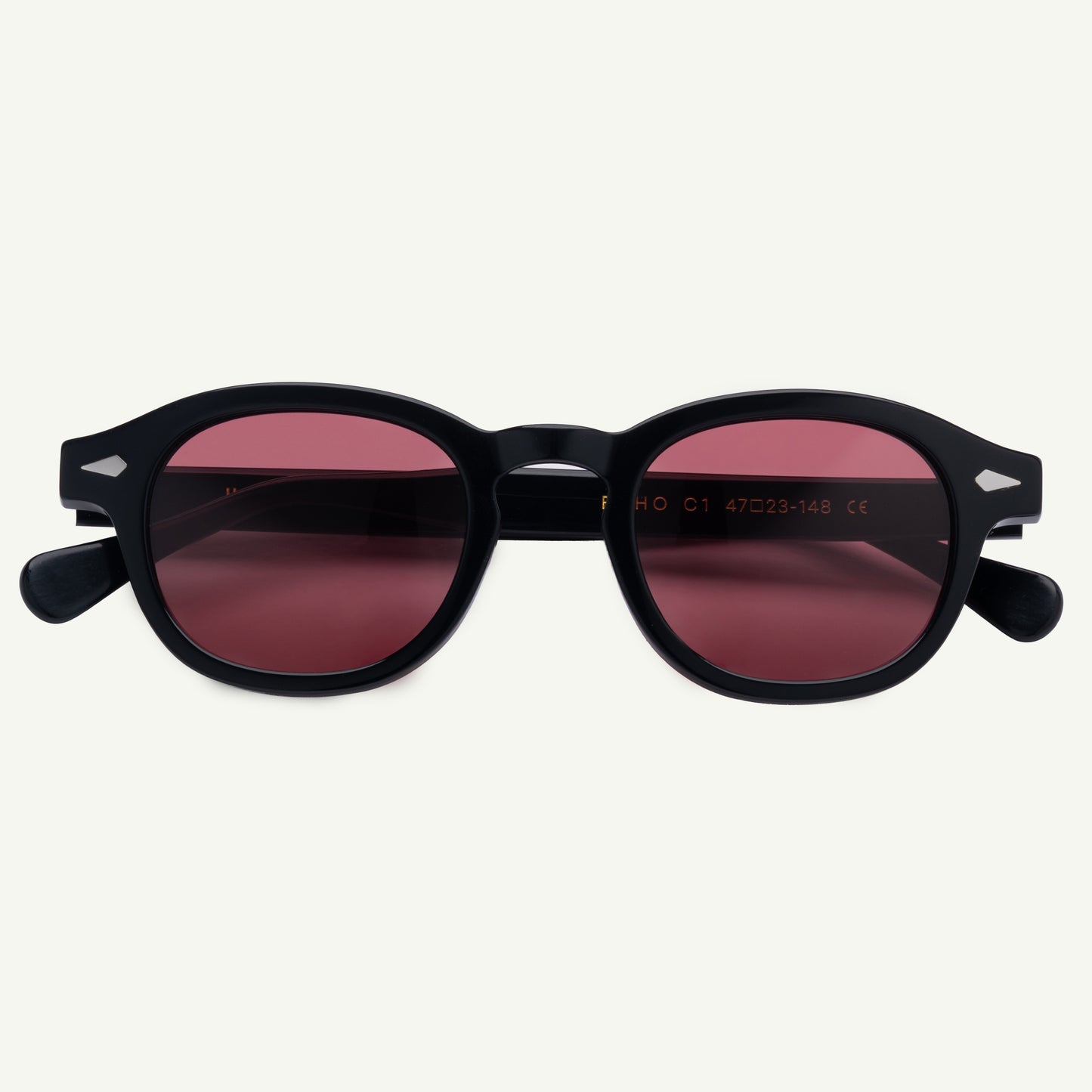 Black sunglasses with red-tinted lenses on a white background
