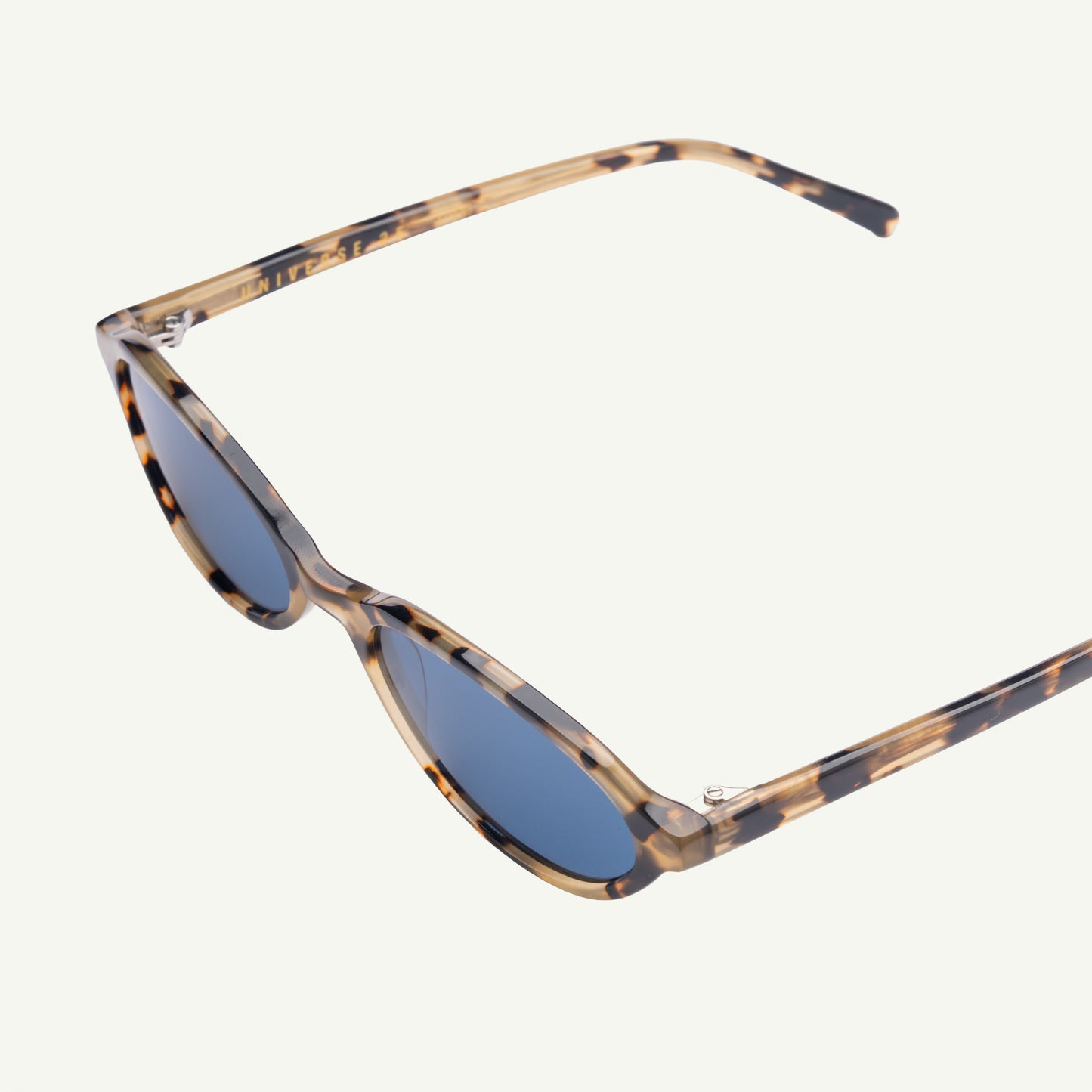 Sunglasses with tortoiseshell frame and blue lenses on a white background