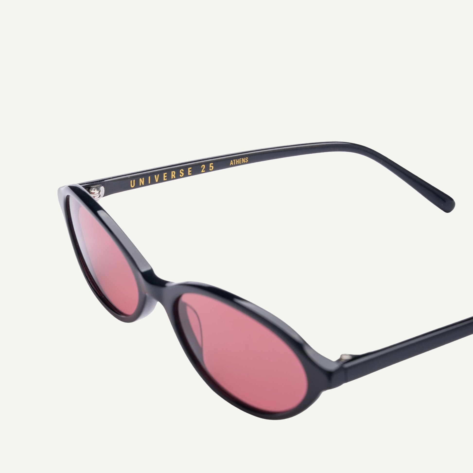 Sunglasses with black frame and pink lenses on a white background