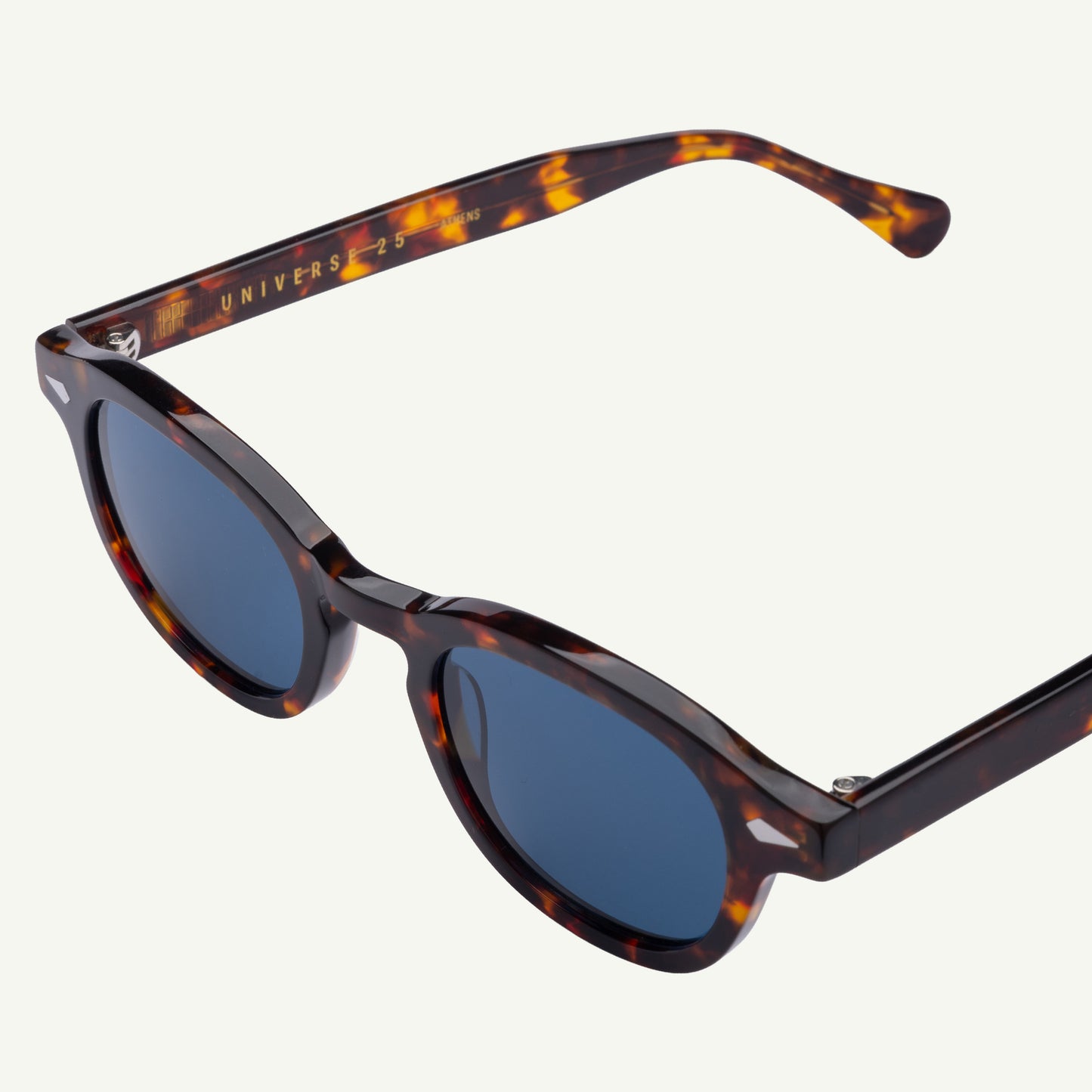 Sunglasses with tortoiseshell frame and blue lenses on a white background